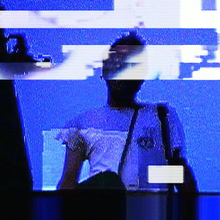 A glitchy image of a person looking down at the camera. 