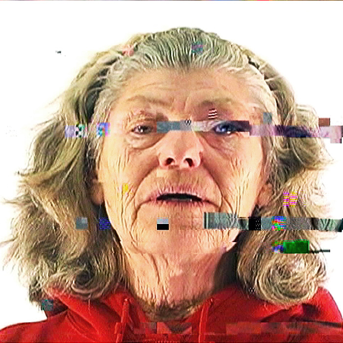 A glitchy image of an older woman looking directly at the camera on a white background.