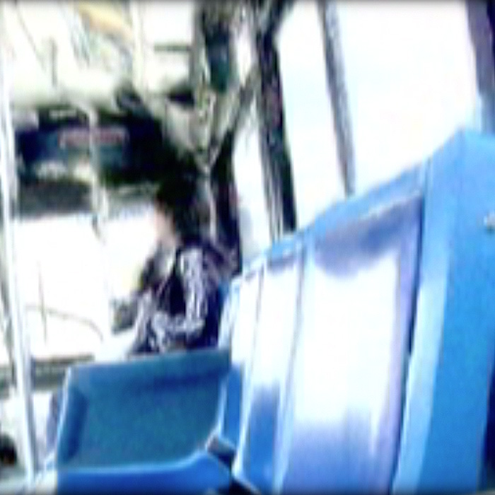 A glitchy image of a person on a bus.