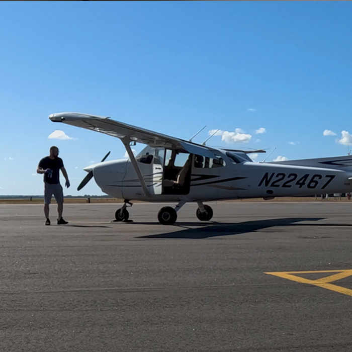 A man standing near an airplane.